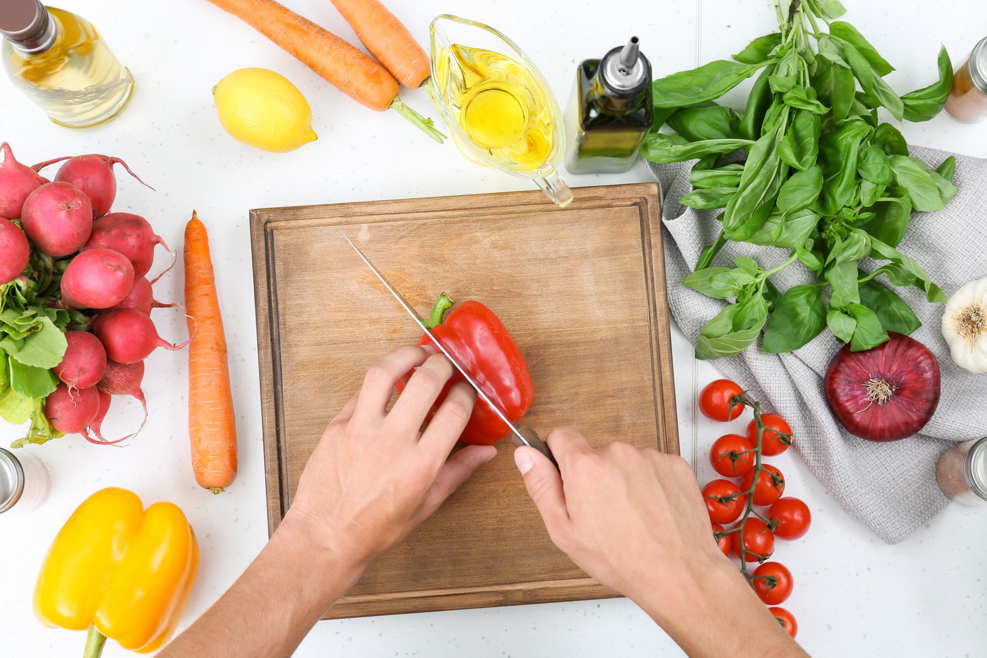 Hand teaching to chop vegetables